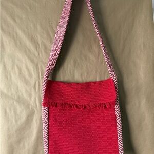 Suruchi crossbody bag with zipper and flap. Red with pattern on side. Handmade